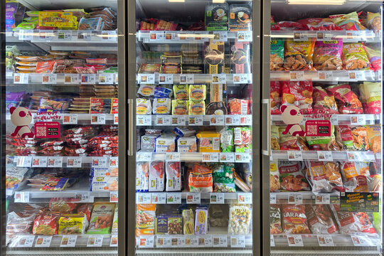 Bangsar, Malaysia &ndash; Mar 30, 2025: Assorted frozen processed foods including nuggets, sausages, meatballs, and ready-to-eat meals neatly arranged in a supermarket freezer aisle at Aeon grocery.