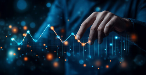 _E Businessman touching an upward graph line icon representing growth and success on a virtual screen, against a blue background. 