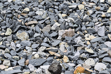 Photo of gravel stones. black small road stone background, dark gravel pebbles stone texture seamless texture. Gray or grey small rocks ground. 