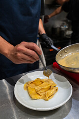 Chef plating a gourmet dish in a professional kitchen