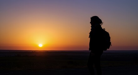 Silhouette of a Traveler at Sunrise