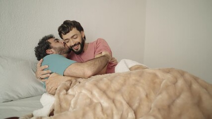 Gay couple sharing intimate moments in bed