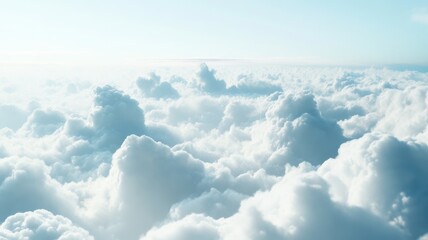 Fototapeta premium Serene View Above a Sea of Fluffy White Clouds: A tranquil aerial perspective shows a vast expanse of soft, white cumulus clouds stretching to the horizon under a clear, pale blue sky.