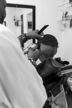 Razor cutting young boys hair at the barber
