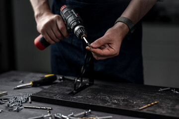 Master Holds Screwdriver With Screw In Hands Close-Up