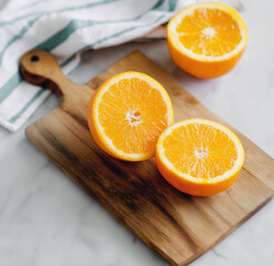 Freshly cut oranges resting on wooden cutting board