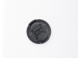 back side of a plastic camera lens cover on a white background. This is a protective element that fits over the front element of the lens to protect it from dust, scratches and other damage