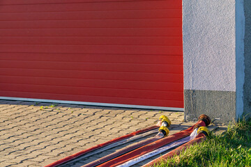 Drying fire hoses in front of the fire station after the rescue operation and fire. Fragment of the...