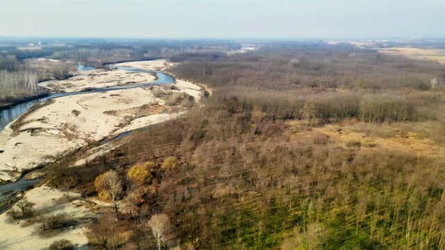 360&deg; aerial drone view of the Orco Stream in Montanaro, Italy. Scenic natural landscape with flowing water and lush greenery. Perfect for nature, travel, and outdoor projects.