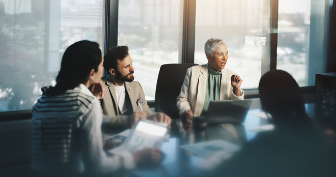 Discussion, group and mature woman with laptop, team and planning for financial growth in business. Corporate, accountant and monitoring performance with charts, people and info for productivity