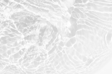 White water with ripples on the surface. Defocus blurred transparent white colored clear calm water surface texture with splashes and bubbles. Water waves with shining pattern texture background.