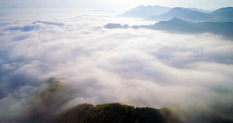 Aerial view of sea of clouds over mountain landscape, dreamy nature scenery