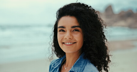 Travel, smile and woman at ocean for holiday, vacation and thinking outdoor for adventure. Beach, relax and happy person in portrait at sea for summer trip, reflection and tourist on island in Spain