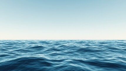 A vast expanse of deep blue ocean meets a light blue sky at the horizon.
