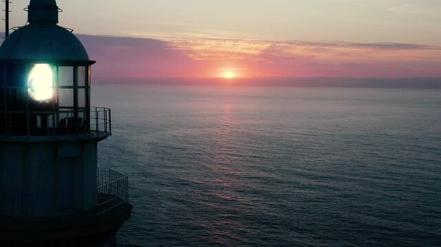 Aerial viewof a beautiful sunrise over the sea horizon, in the lighthouse of La Nao Cape, Alicante, Spain.