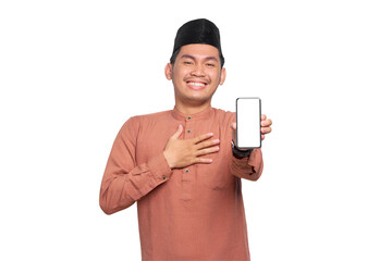 Amazed young Asian Muslim man showing mobile phone blank screen recommending App isolated on transparent background