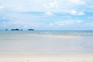 tropical beach with blue sky and clouds