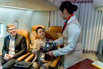 Businessman receiving in-flight beverage service from smiling flight attendant during air travel, corporate hospitality, premium class airline experience