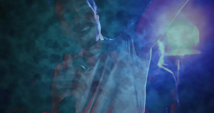 male singer raising arm singing on stage using microphone amid animated smoke for music marketing