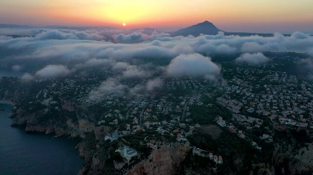 Aerial time lapse over the clouds in La Nao Cape lighthouse, in Javea, Mediterranean Sea, Spain.
