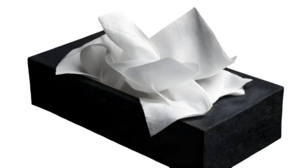Package of white wipes with some sheets pulled out, isolated on a black studio background