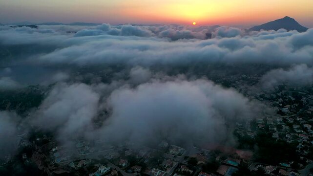 Aerial time lapse over the clouds in La Nao Cape lighthouse, in Javea, Mediterranean Sea, Spain.