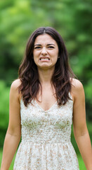 Naklejka premium Woman expressing disgust in a lush green outdoor setting 