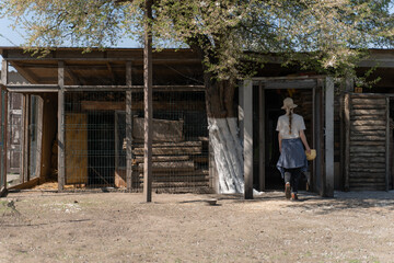 Young Woman Gardener Holding Watering Can on a Sunny Farm Day