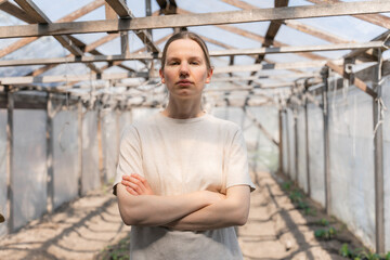Young beautiful woman in a green house