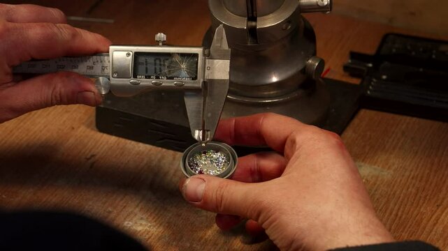 Skilled jeweler meticulously measures zirconium gemstones