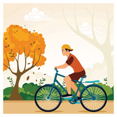 Obraz premium Young person riding a bicycle through an autumn landscape.
