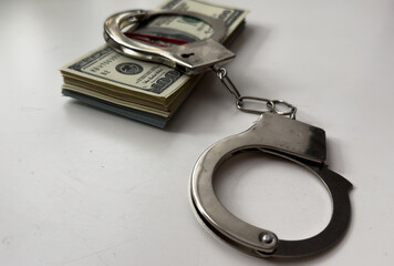 many dollar bills with handcuffs