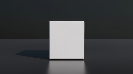 A white cube on a black surface.