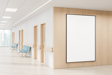 Bright hallway interior with blank poster mockup on wooden wall in modern medical or office facility for clean advertising or design presentation concept. 3D Rendering