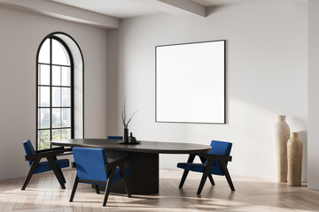 Modern interior with blank poster mockup on bright wall above dark table and blue chairs in clean minimalist room with natural light and decor elements. 3D Rendering