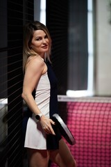 Young athletic woman tennis padel player posing with racket on tennis padel court