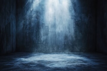 A dark room with a single spotlight illuminating the dusty floor and walls