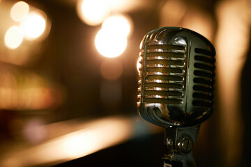 Close up on shiny vintage styled stand microphone shining in jazz club lights