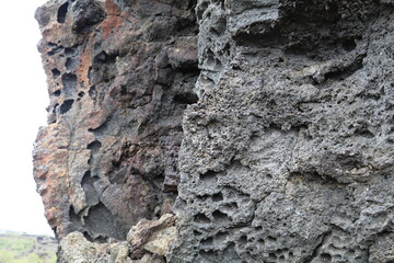 Black lava rock formation with different textures