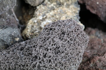 Black lava rock formation with different textures