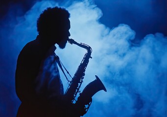 Obraz premium A silhouetted figure of a saxophone player in the dark, with the instrument's outline visible against a blue background filled with smoke and fog. 
