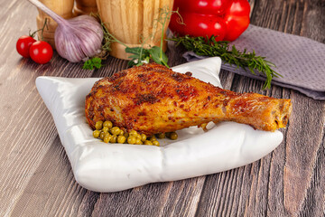 Baked turkey drumstick served green peas