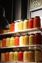 GLASS JARS OF OLIVES AND CHILLI PEPPERS