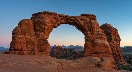 Natural sandstone arch formation against blue sky at golden hour. Geological wonder landmark. Erosion-created monument. attraction. Environmental conservation site. Desert landscape. Travel