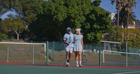 Tennis court, couple and interracial people for match, game or competition. Fitness, sports racket and mature athlete man with woman for training, workout and weekend hobby for health and wellness