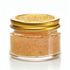 Golden, granular body scrub in a clear jar with a gold lid.