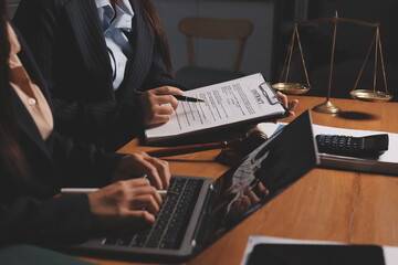 Attractive young lawyer in office Business woman and lawyers discussing contract papers with brass...