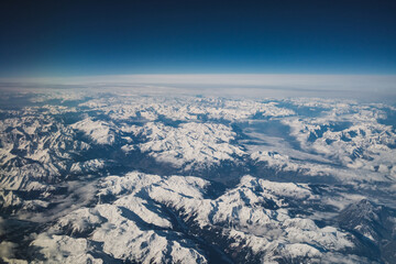 Naklejka premium Snowy Mountain Tops Seen From Plane 