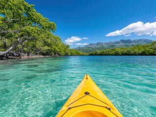 Kayaking through crystal-clear turquoise waters, surrounded by lush greenery and mountains under a vibrant blue sky