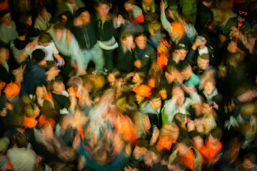 Crowd wearing orange dancing happily during street party on Koningsnacht King's Night 2025 © Sarah